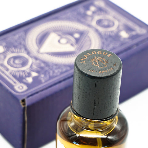 Bottle of Yama Oil de Parfum with rose and Sakura floral notes showing wooden cap, available in Singapore & SE Asia.
