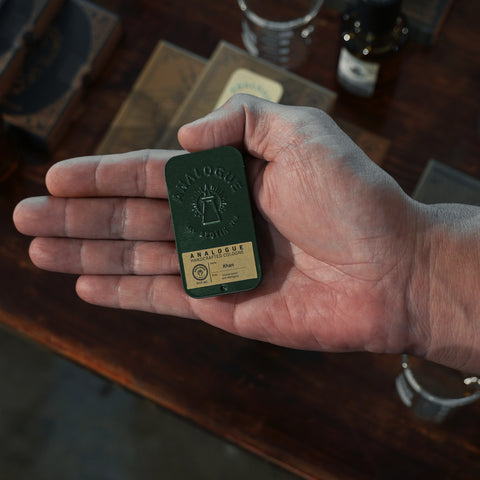Compact tin of Khan Solid Cologne with citrus, spice and sandalwood, handcrafted for Singapore & Worldwide.