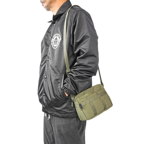 Side profile of model carrying OriGinaLe Origo Sling Bag in olive Technical Canvas in Rugged Gentlemen Shoppe Singapore.