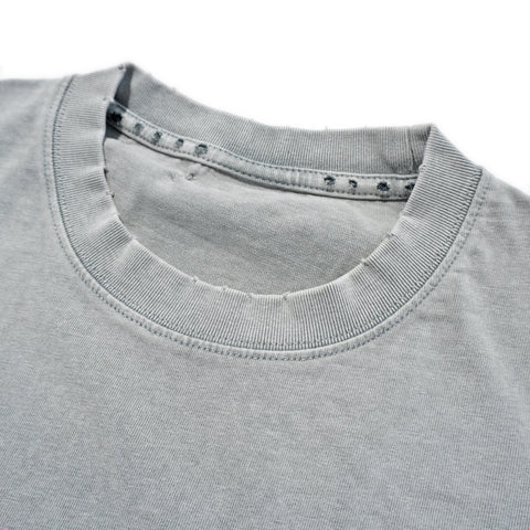 Close-up ribbed collar and distressed pinhole detailing on vintage grey cut-off tee