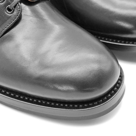 Close-up toe-box view of OGL BRAVE plain-toe Derby shoe showing black horsehide leather, welt stitching