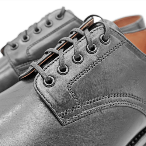 Close-up view of OGL BRAVE plain-toe Derby shoe showing neat stitching construction at lace area and leather quality