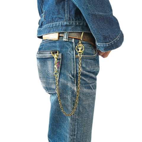 OGL brass wallet chain worn with faded selvedge denim jeans, secured to a leather wallet and belt.