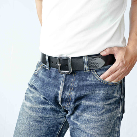 Model wearing OGL Single-Prong Garrison Leather Belt Full-Dyed Black, Sleek Design with thick stainless steel buckle