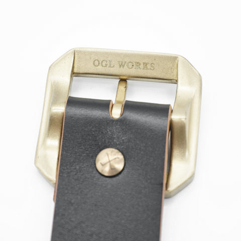 OGL Single-Prong Garrison Leather Belt Hand-Dyed Black showing OGL Works solid brass buckle, unique tea-core