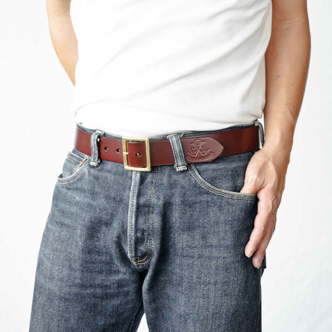 Model wearing OGL Vintage 1.5 Leather Belt Full-Dyed Tan handmade full-grain leather solid brass buckle heritage in raw denim