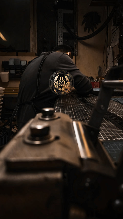 craftsman working on handmade leather belt at workbench