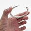 OGL OBBI GOOD LUCK HAND-HAMMERED SILVER BANGLE