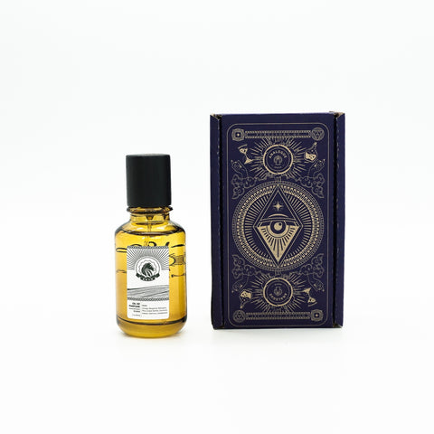Bottle of Khan Oil de Parfum featuring citrus, amber and sandalwood, available in Singapore & Worldwide.