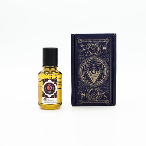 Bottle of Omni Oil de Parfum with leather, rose and dark berry notes, available in Singapore & SE Asia.