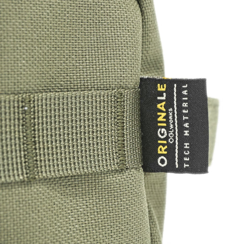 ORIGO Utility Dopp Kit in olive abrasion-resistant technical canvas close-up showing OriGinaLe tech material label by Obbi Good Label.