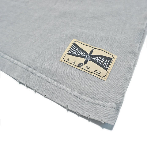 Heritage General Store woven label with distressed hem on vintage grey cut-off tee
