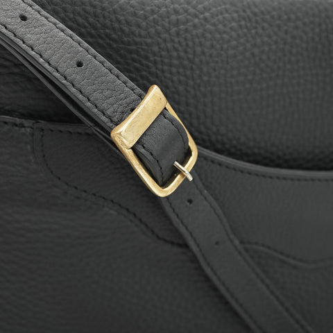 Close-up of solid brass buckle on premium tumbled full-grain leather grain on OGL 9981 handbag