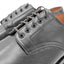 Close-up view of OGL BRAVE plain-toe Derby shoe showing neat stitching construction at lace area and leather quality