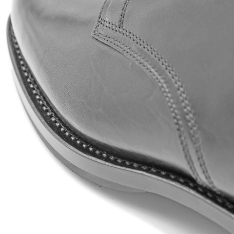 Close-up side view of OGL BRAVE plain-toe Derby shoe showing black horsehide leather, welt stitching