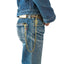 OGL brass wallet chain worn with faded selvedge denim jeans, secured to a leather wallet and belt.